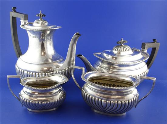 An Edwardian four piece demi fluted silver tea and coffee set, in a fitted two-handled oak presentation case, gross 58 oz.